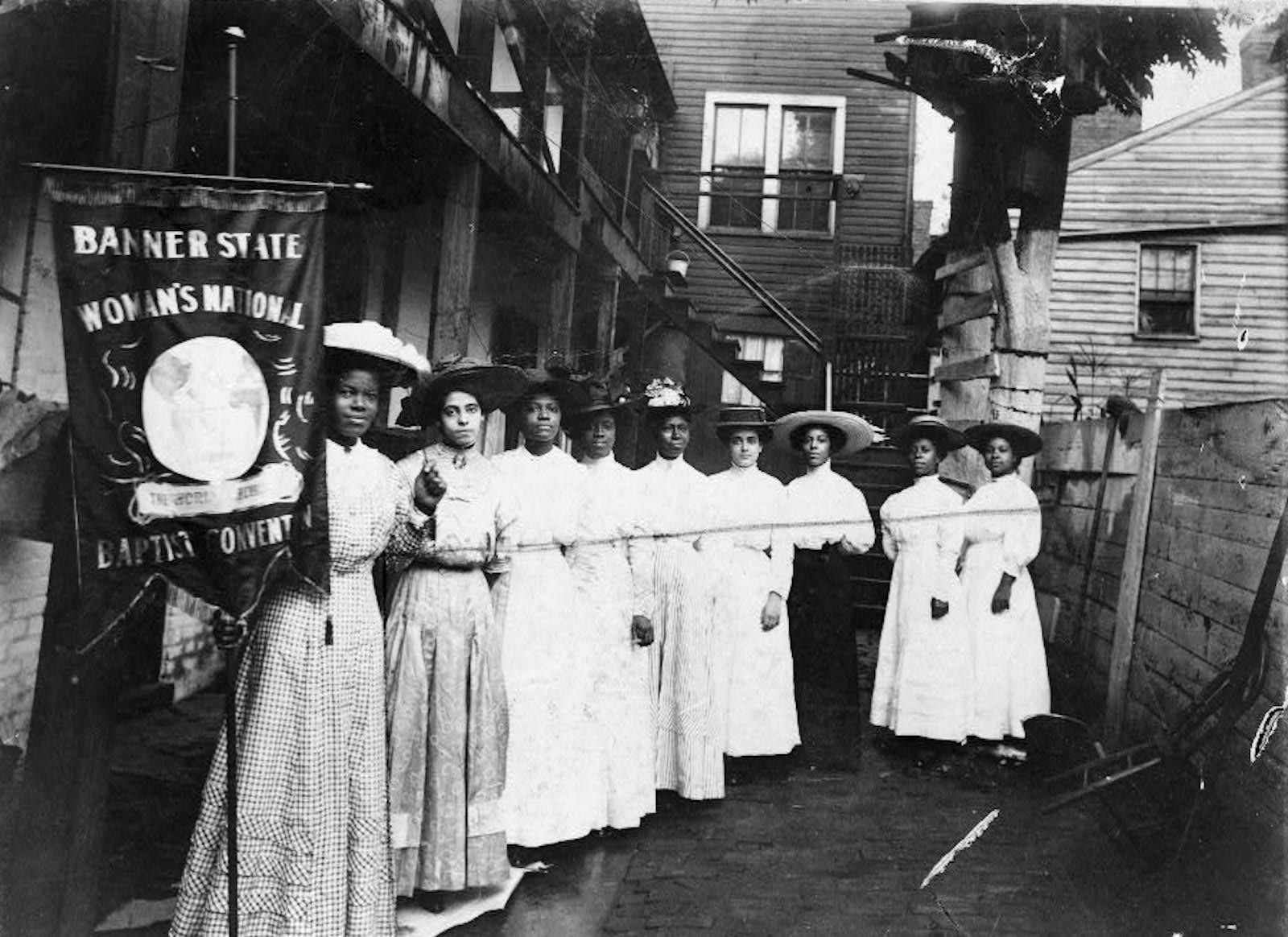 African-American suffragist Nannie Helen Burroughs, far left, at the Banner State Woman’s National Baptist Convention in 1915. Library of Congress. Public Domain. African-American suffragist Nannie Helen Burroughs, far left, at the Banner State Woman’s National Baptist Convention in 1915. Library of Congress. Public Domain.